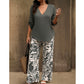 Un completo composto da una blusa da donna con scollo a V e pantaloni a gamba larga con fantasia.